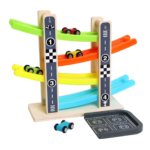 A toddler playing with a colorful four-tier wooden car glider ramp toy, watching a small wooden car zoom down the tracks to develop hand-eye coordination and tracking skills in a bright, modern nursery.